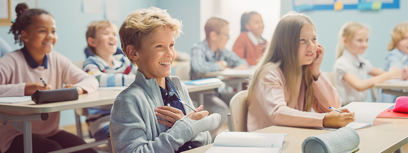 Diverse middle school students in class listening to lesson