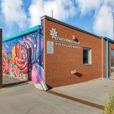 exterior of brick building with colorful mural