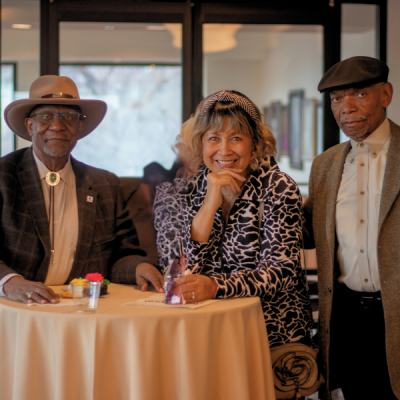 three people posing behind a table during the Juanita Gray Community Service Awards